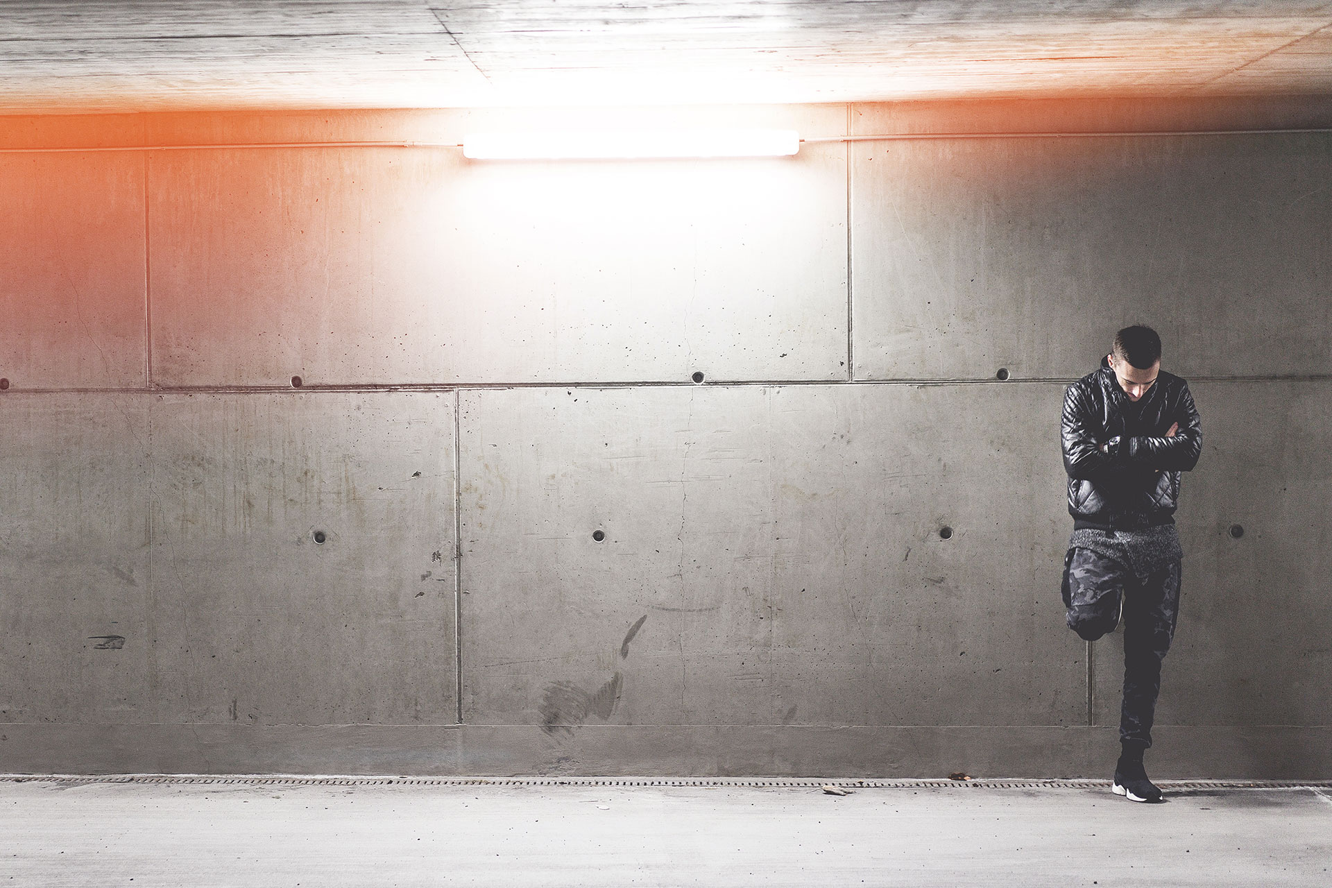 young-man-standing-in-front-of-concrete-wall-picjumbo-com_1484133111_0.53137400.jpg