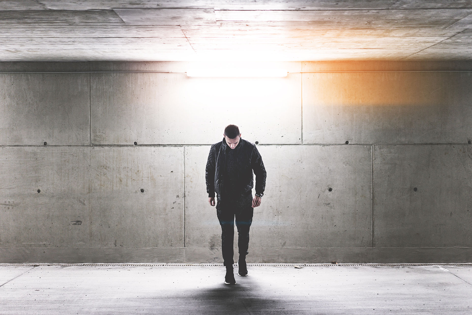 young-man-walking-in-conrete-underground-walkway-picjumbo-com_1485784938_0.94990900.jpg